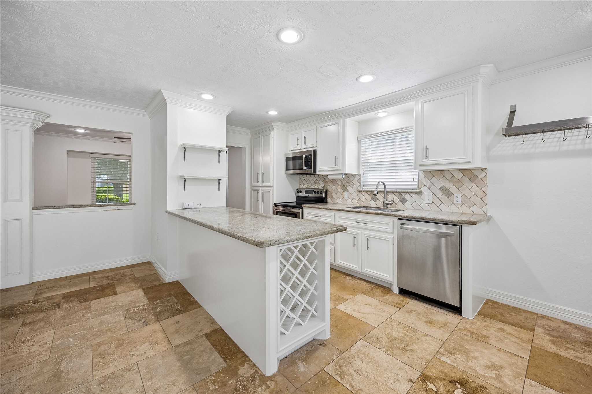 5019 Kinglet Street Houston, TX 77035 - Photo 10 of 24 Open kitchen boasts breakfast bar, offering the perfect space for living & entertaining family & friends. Abundant storage, including convenient wine/beverage storage!