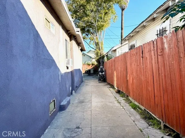 a view of a pathway of a building with wooden fence