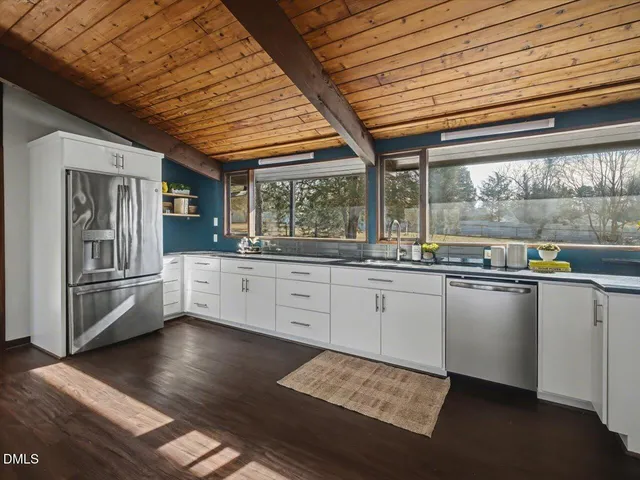 a living room with lots of furniture wooden floor and a rug