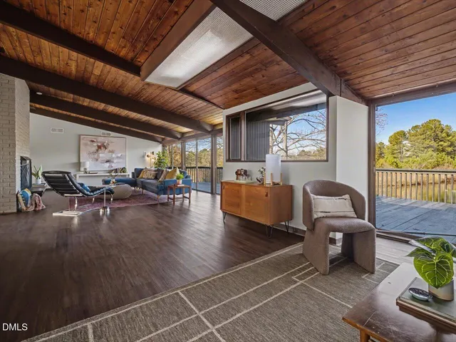 a bed sitting in a spacious bedroom next to a window