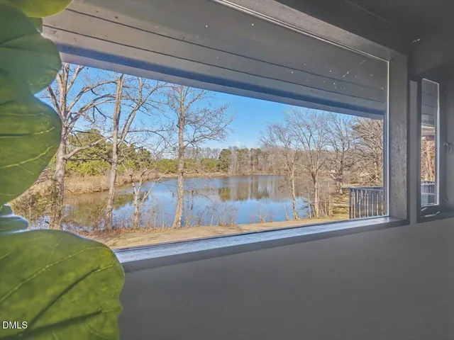 a view of a dining room with furniture and a window