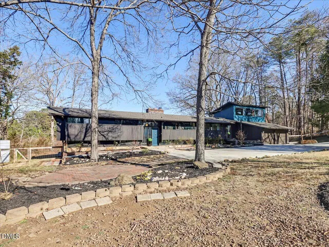 a view of a hallway with wooden floor and a large window