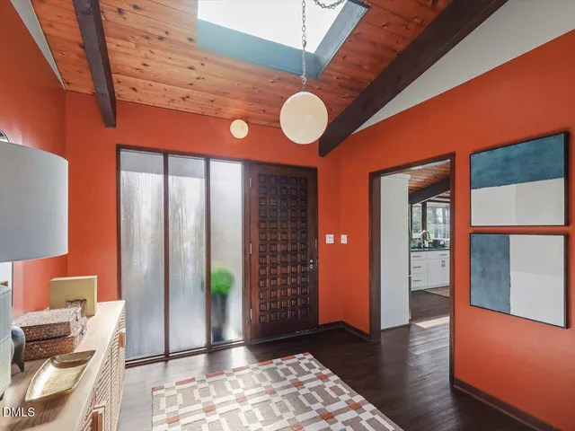 a kitchen with stainless steel appliances granite countertop wooden floors and white cabinets