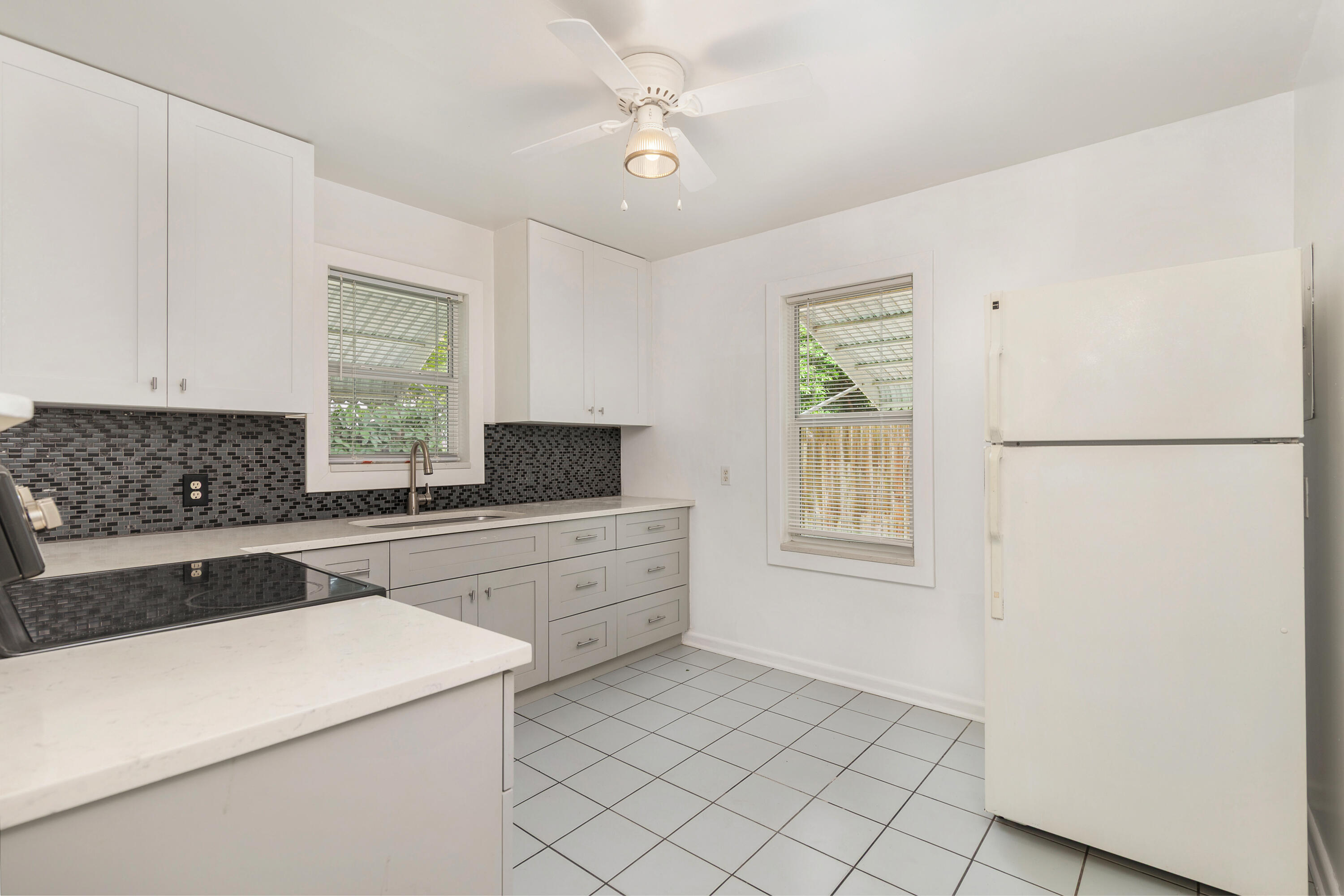 429 49th Street, Unit 2 West Palm Beach, FL 33407 - Photo 2 of 10 a kitchen with a stove a sink and a refrigerator