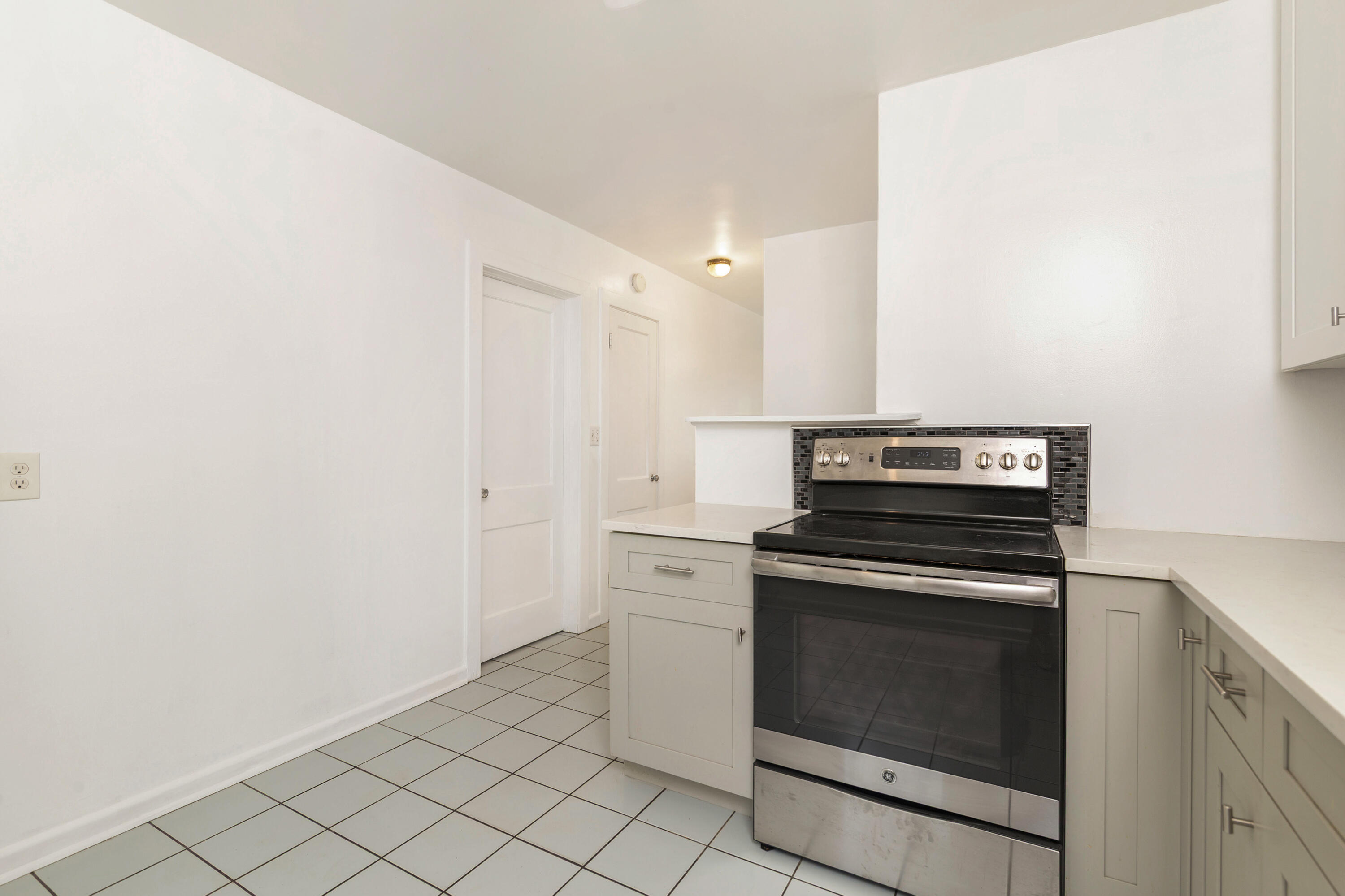 429 49th Street, Unit 2 West Palm Beach, FL 33407 - Photo 5 of 10 a kitchen with a stove and a microwave