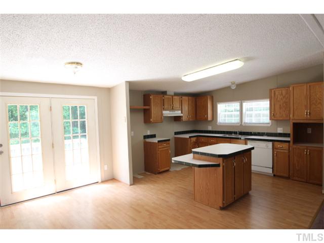 5949 Oxford Road Timberlake, NC 27583 - Photo 2 of 12 a kitchen with kitchen island granite countertop a sink counter top space and stainless steel appliances