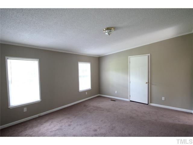 5949 Oxford Road Timberlake, NC 27583 - Photo 7 of 12 a view of an empty room with a window