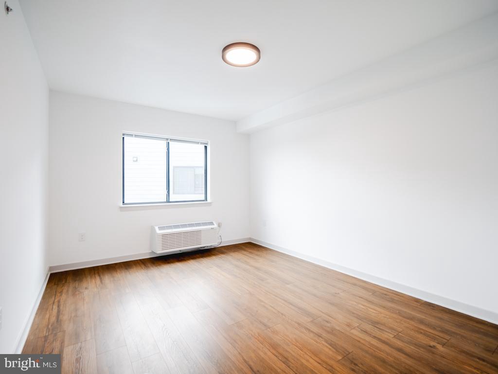 6515 Ridge Avenue, Unit 304 Philadelphia, PA 19128 - Photo 4 of 14 an empty room with wooden floor and windows