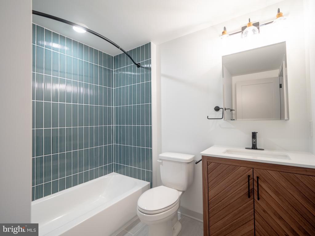 6515 Ridge Avenue, Unit 304 Philadelphia, PA 19128 - Photo 6 of 14 a bathroom with a sink a toilet and shower