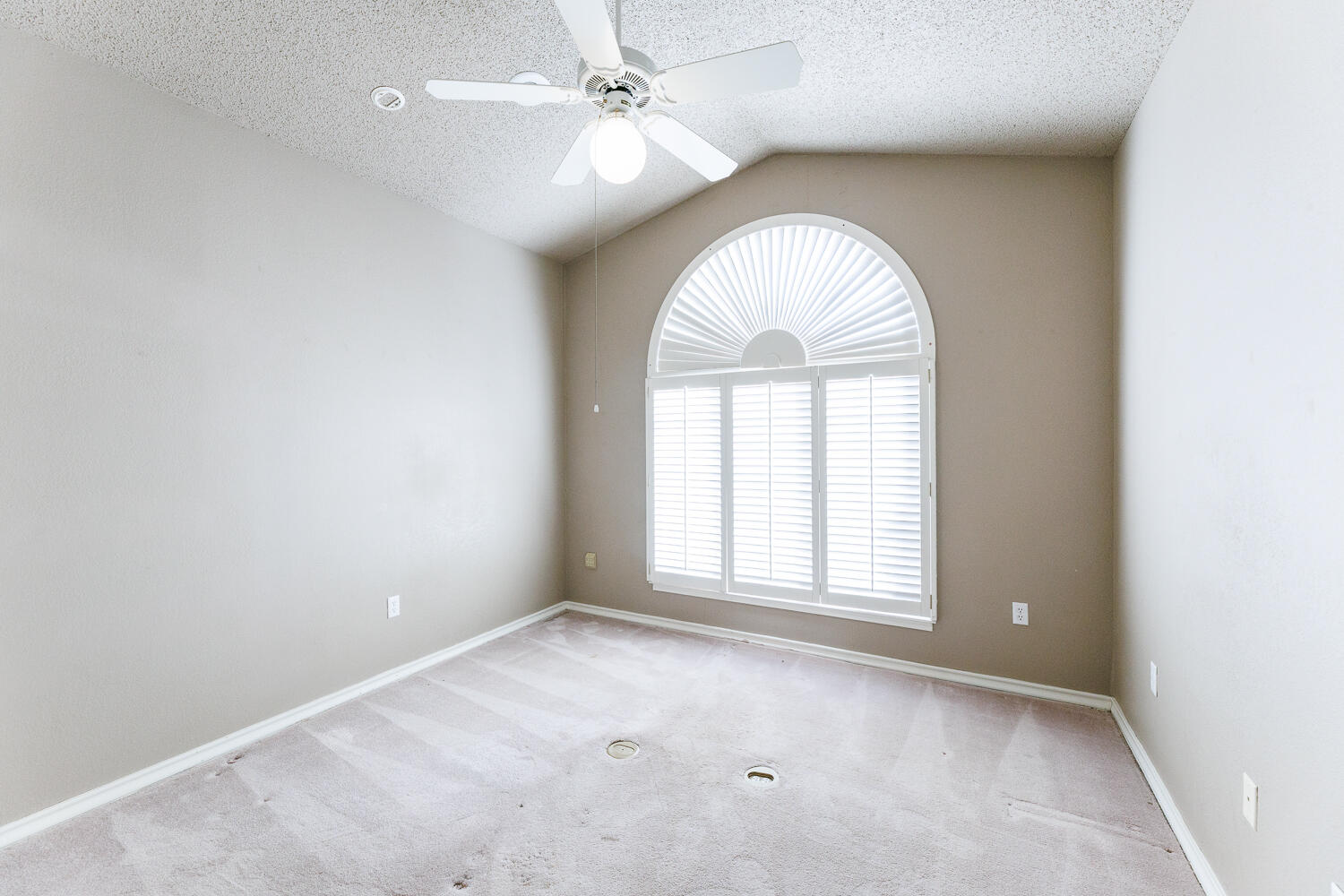 206 Collins Avenue Sundown, TX 79372 - Photo 50 of 82 an empty room with a chandelier fan and windows