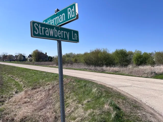 a view of a street with a sign board