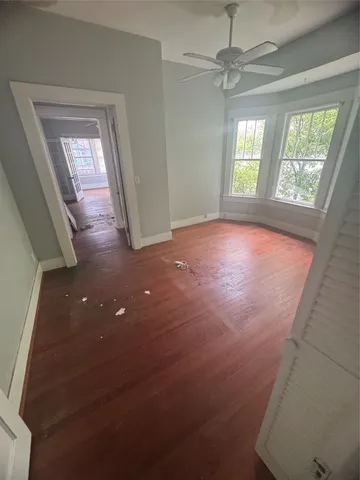 an empty room with windows and closet