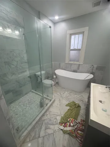 a bathroom with a toilet and a shower