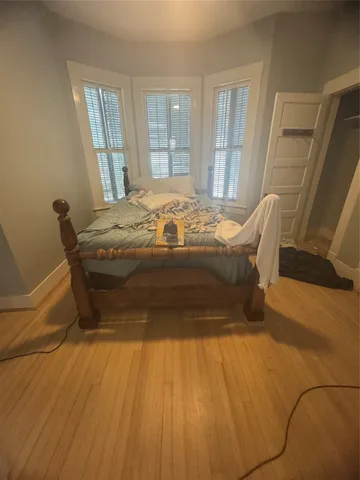 a bed sitting in a bedroom next to a window