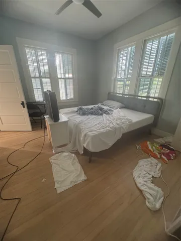 a bed sitting in a bedroom next to a window