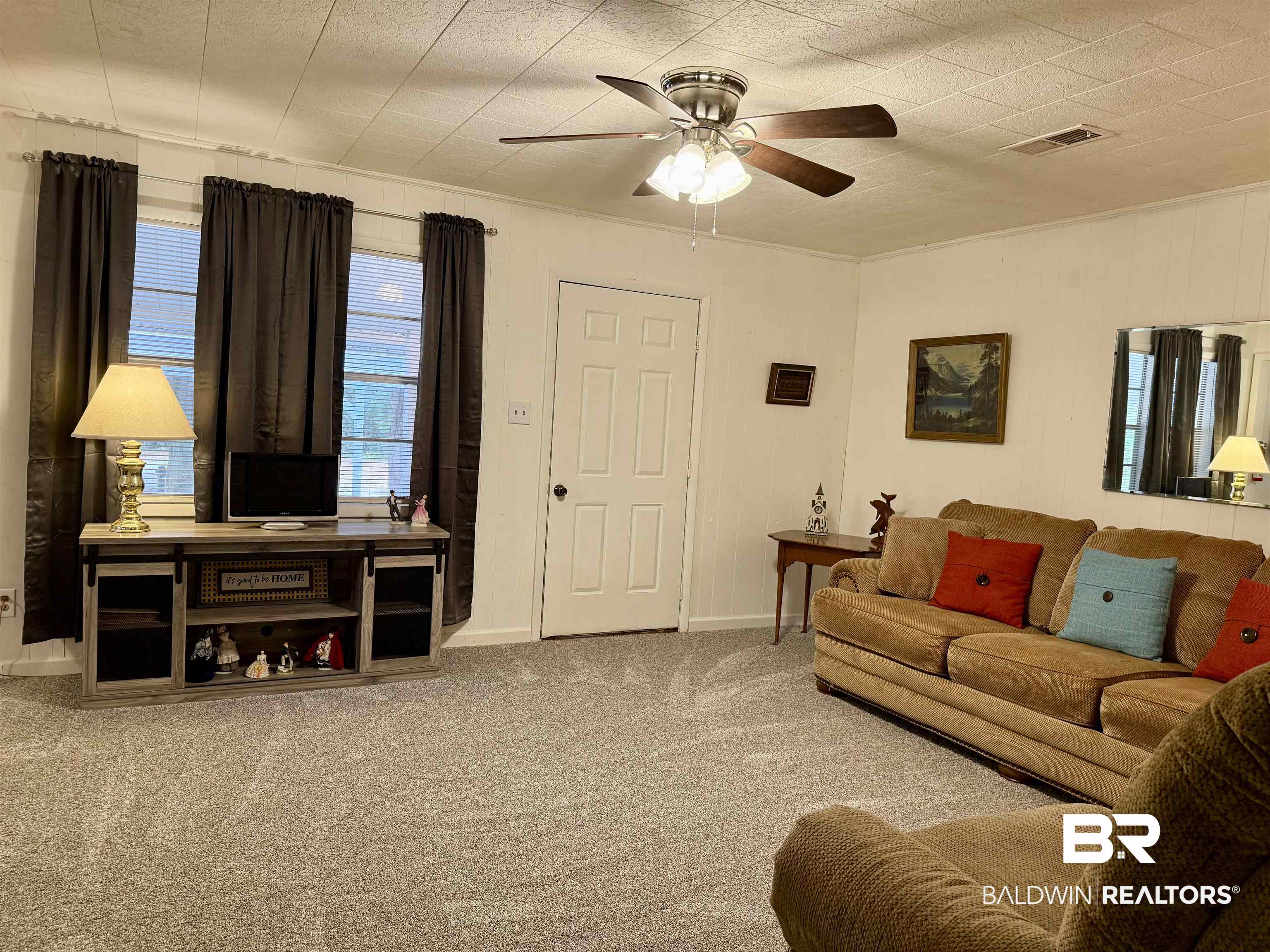 826 West Side Road Castleberry, AL 36432 - Photo 4 of 34 Carpeted living room featuring baseboards and ceiling fan
