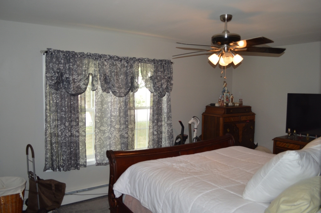 75 Eagle View Drive Douglas, MA 01516 - Photo 18 of 28 a bedroom with a bed and a chandelier