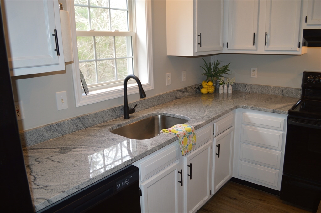 75 Eagle View Drive Douglas, MA 01516 - Photo 2 of 28 a kitchen with stainless steel appliances granite countertop a sink a stove and cabinets