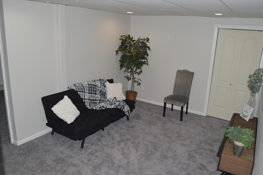 75 Eagle View Drive Douglas, MA 01516 - Photo 22 of 28 a living room with furniture and a chair