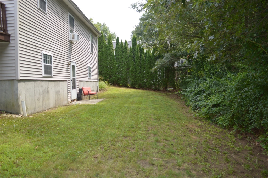 75 Eagle View Drive Douglas, MA 01516 - Photo 25 of 28 a view of a backyard with plants and large trees