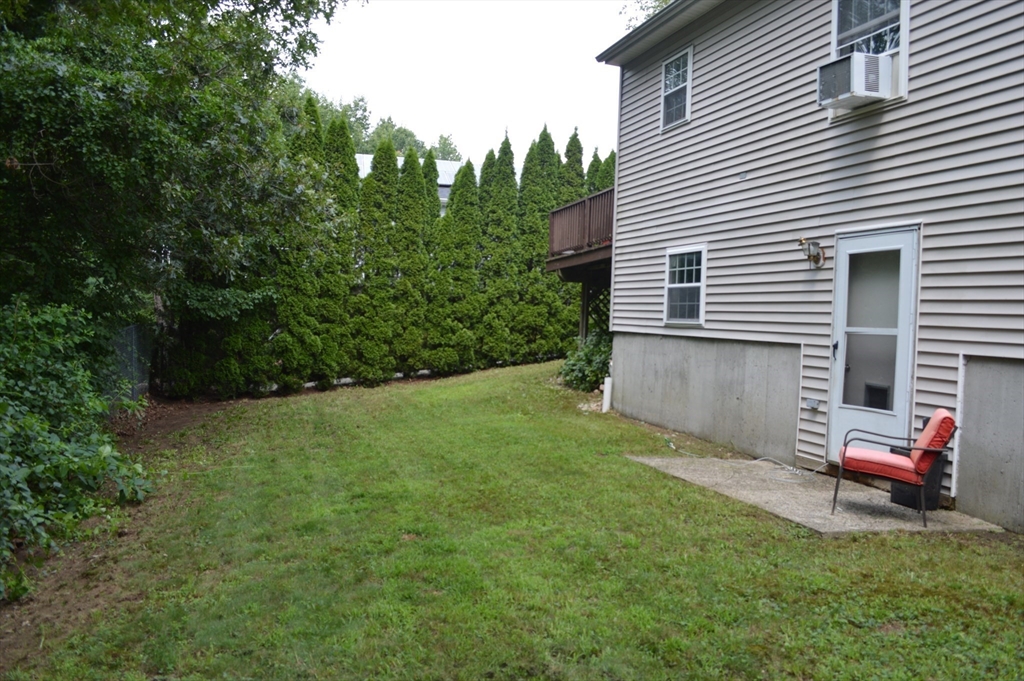 75 Eagle View Drive Douglas, MA 01516 - Photo 26 of 28 a backyard of a house with table and chairs