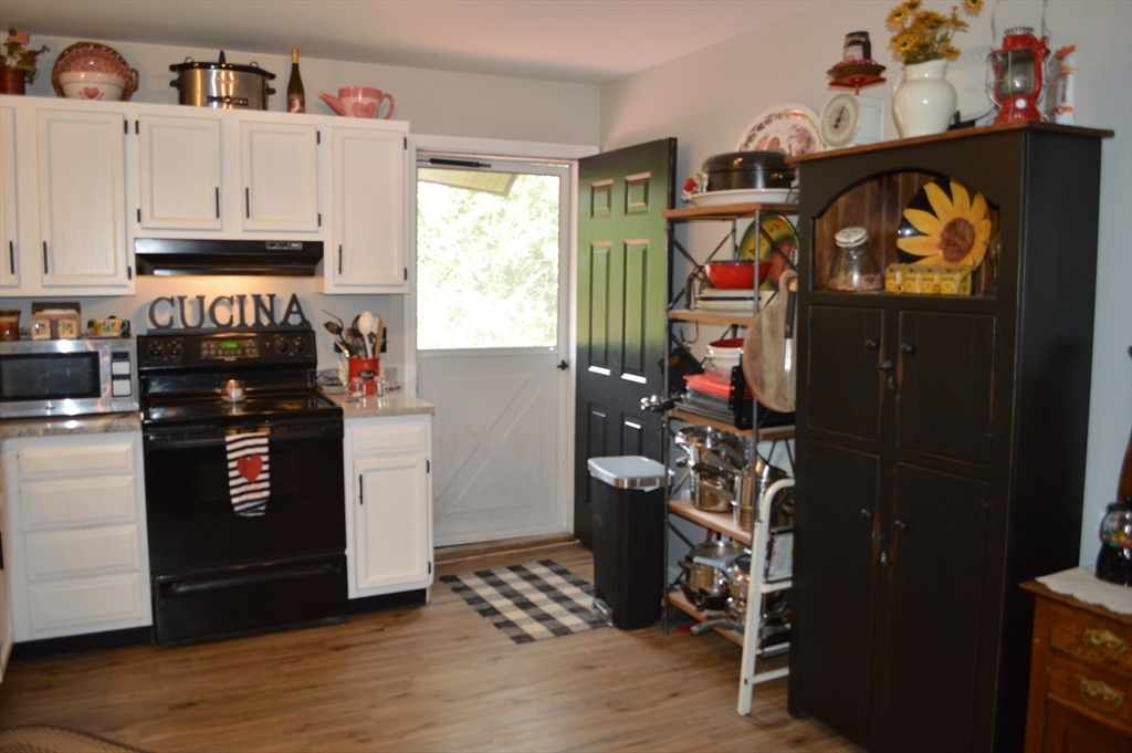 75 Eagle View Drive Douglas, MA 01516 - Photo 4 of 28 a kitchen with stainless steel appliances granite countertop a stove and a refrigerator