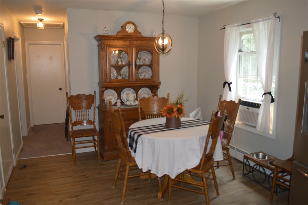75 Eagle View Drive Douglas, MA 01516 - Photo 8 of 28 a dining room with furniture a chandelier and wooden floor