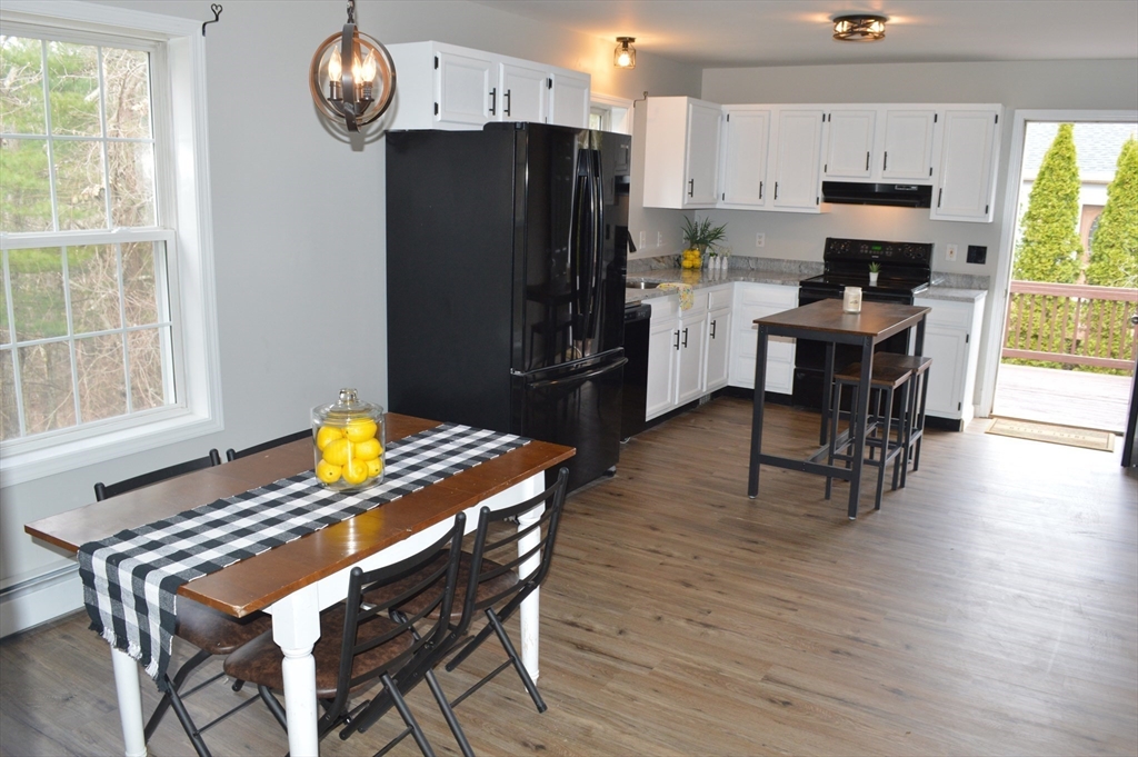 75 Eagle View Drive Douglas, MA 01516 - Photo 10 of 28 a kitchen with a table chairs refrigerator and microwave