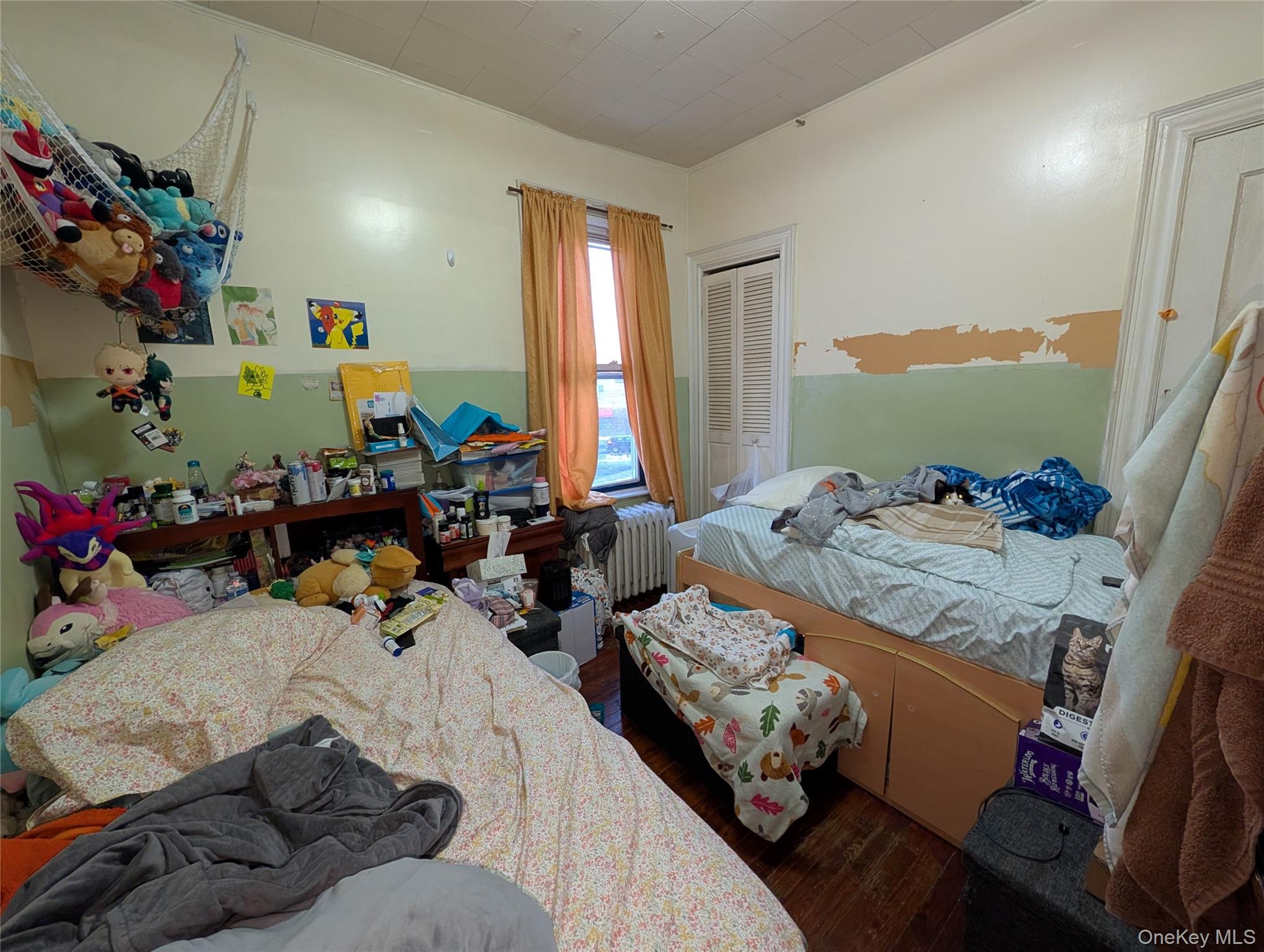 90-46 76th Street Queens, NY 11421 - Photo 15 of 32 a bed room with furniture and a window