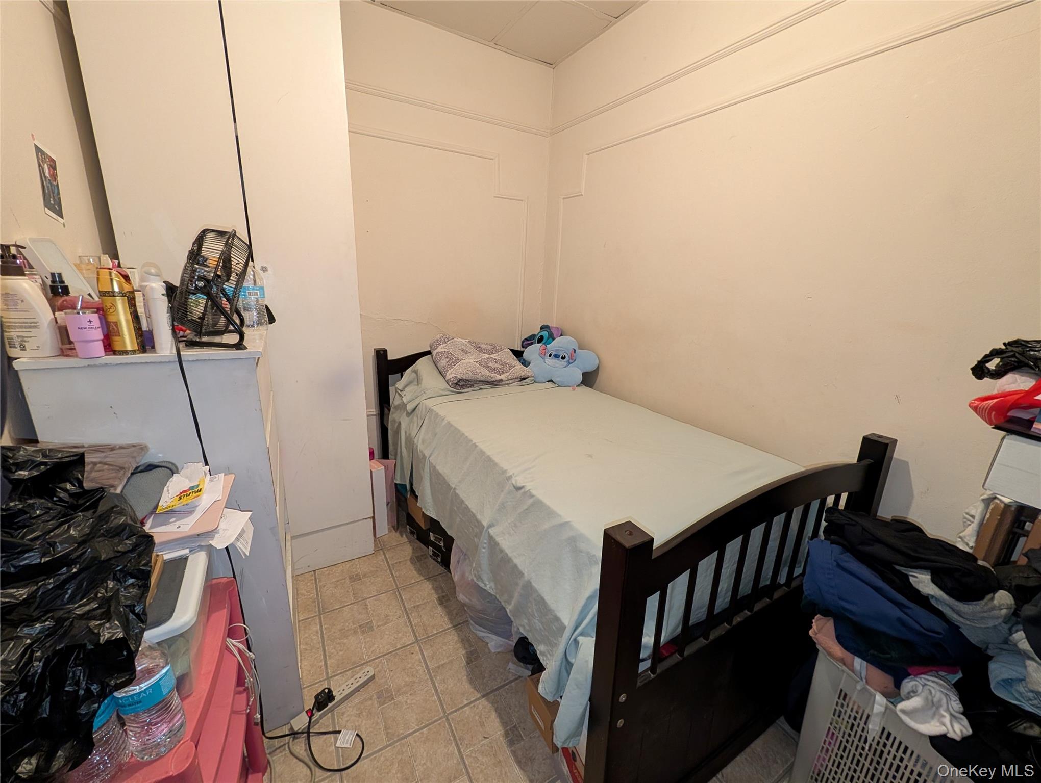 90-46 76th Street Queens, NY 11421 - Photo 18 of 32 a bedroom with a bed and cabinets