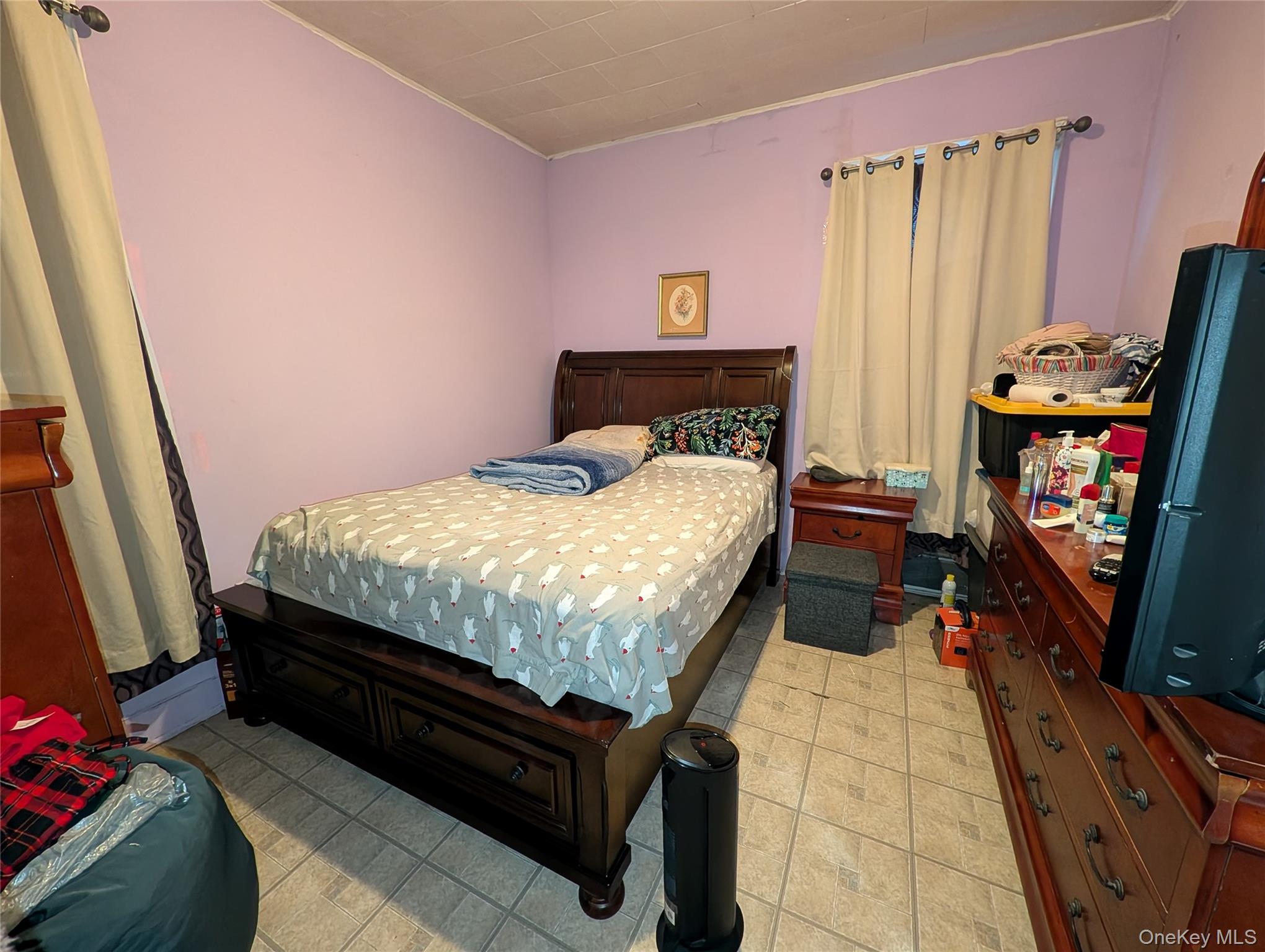 90-46 76th Street Queens, NY 11421 - Photo 19 of 32 a bed sitting in a bedroom next to a window with a baby crib