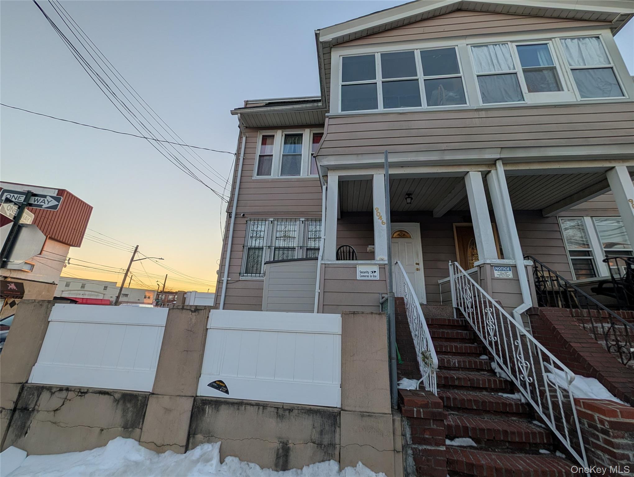 90-46 76th Street Queens, NY 11421 - Photo 2 of 32 a view of a house with stairs and wooden fence