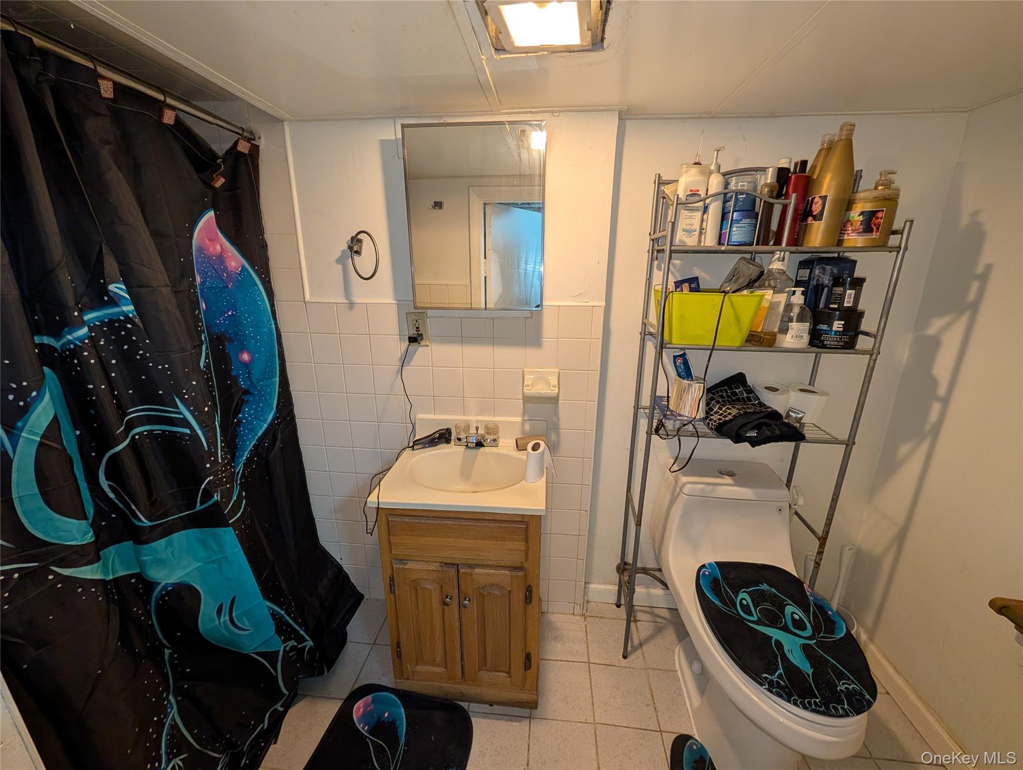 90-46 76th Street Queens, NY 11421 - Photo 26 of 32 a bathroom with a sink toilet and shower