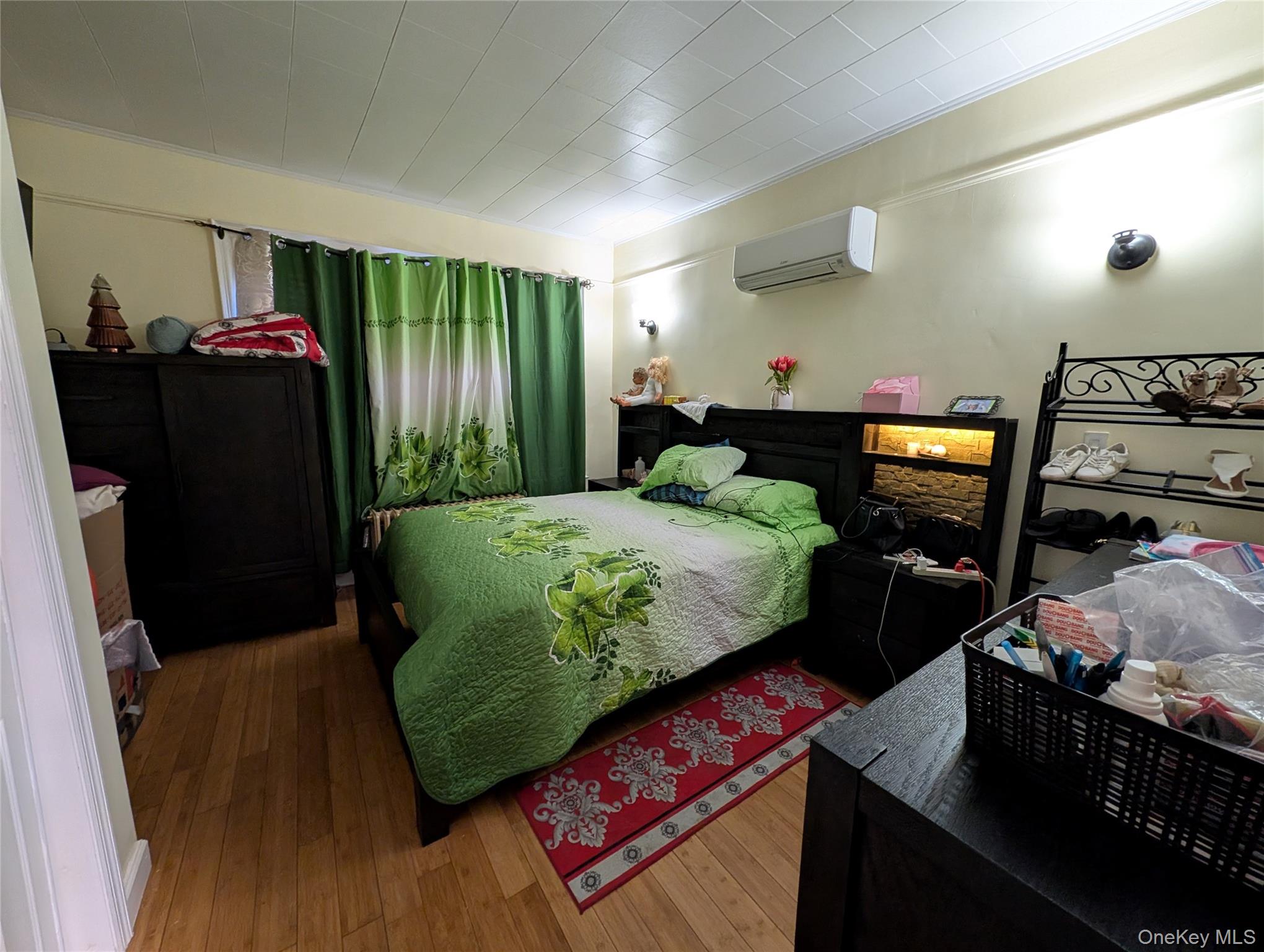 90-46 76th Street Queens, NY 11421 - Photo 8 of 32 a bed sitting in a bedroom next to a window