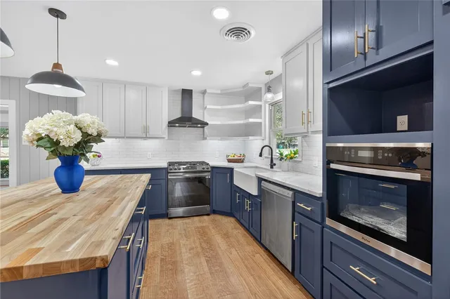 a kitchen with a sink stove top oven and cabinets