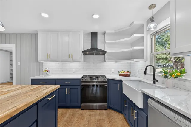 a view of a kitchen island a chandelier and wooden floor