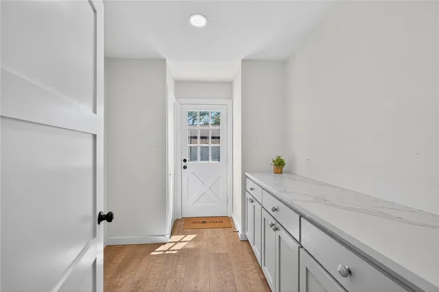 a storage room with wooden floor washer and dryer