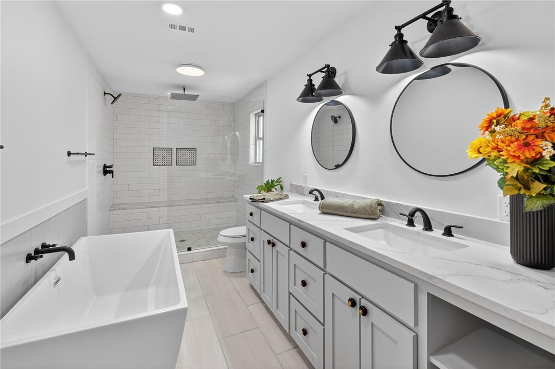 126 Rainbow Lane Corpus Christi, TX 78411 - Photo 24 of 40 a bathroom with a double vanity sink and a mirror