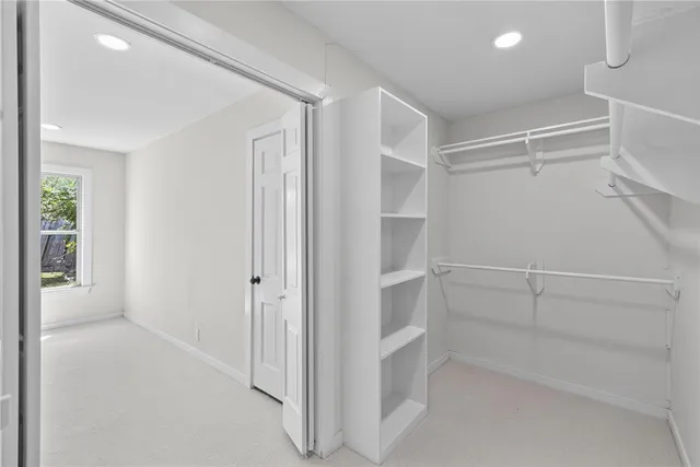 a bathroom with a sink a toilet and a large mirror