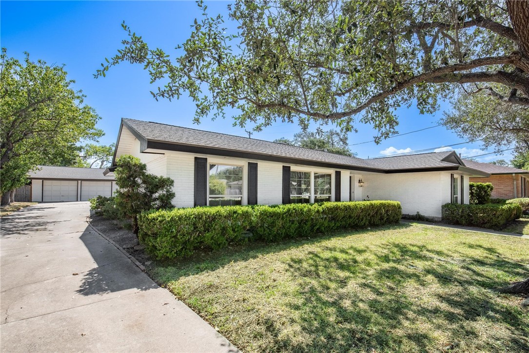 126 Rainbow Lane Corpus Christi, TX 78411 - Photo 35 of 40 a front view of a house with a garden