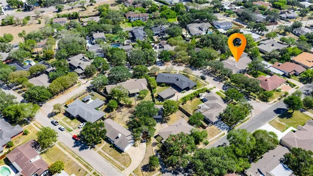 an aerial view of residential houses with outdoor space and swimming pool