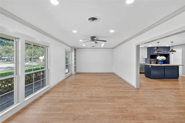 a view of a kitchen with a sink and a refrigerator
