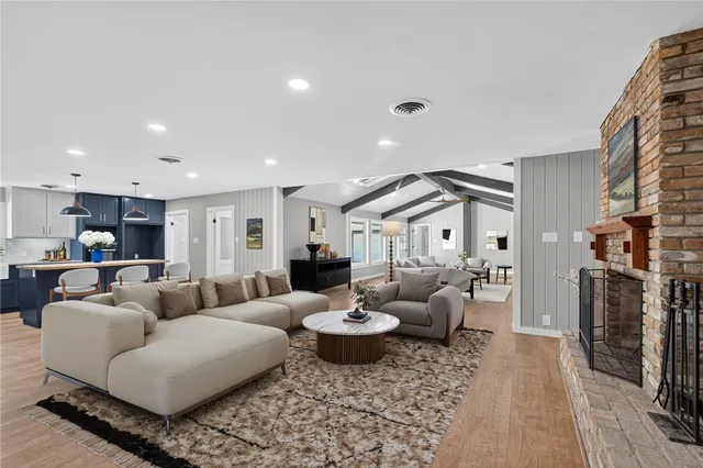 a large kitchen with kitchen island a sink a stove and a refrigerator