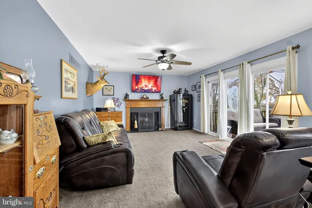 a living room with furniture fireplace and flat screen tv