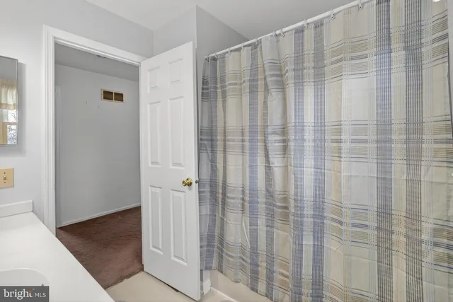 a bedroom with a bed and painting on the wall