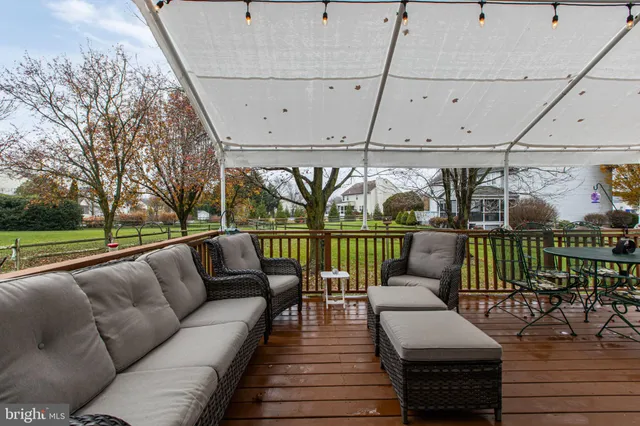 a view of a balcony with chairs and wooden floor