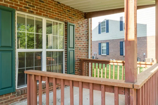 a view of a brick house with large windows