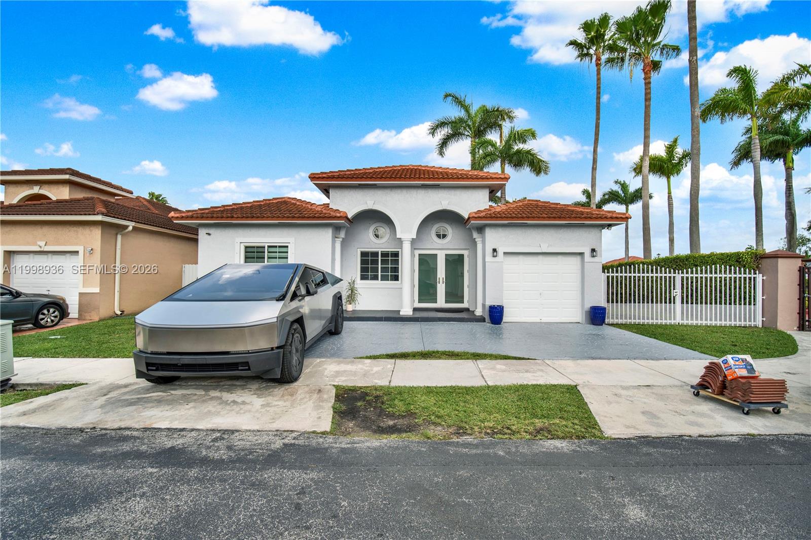 a front view of a house with a yard and garage