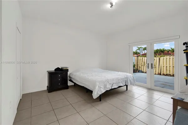 a spacious bedroom with a bed and a table