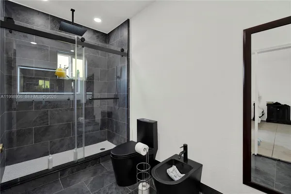 a bathroom with a toilet and a shower